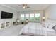 Airy bedroom featuring lots of natural light, ceiling fan, plush seating, and a modern media center at 112 Bellmont Crest Dr, Holly Springs, NC 27540