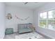 Bright Bedroom featuring a colorful banner, crib, and playroom rug at 112 Bellmont Crest Dr, Holly Springs, NC 27540