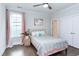 Cozy bedroom with stylish decor, a ceiling fan, and natural light from a large window at 112 Bellmont Crest Dr, Holly Springs, NC 27540