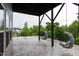 Spacious covered patio featuring swing chairs, offering a tranquil spot to relax and enjoy the scenery at 112 Bellmont Crest Dr, Holly Springs, NC 27540
