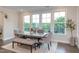 Cozy dining area featuring natural light, a rustic table, and scenic outdoor views at 112 Bellmont Crest Dr, Holly Springs, NC 27540
