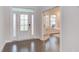 Inviting foyer with a decorative glass door, hardwood floors, and an adjacent office space at 112 Bellmont Crest Dr, Holly Springs, NC 27540