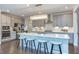 Modern kitchen with stainless steel appliances, an island with seating, and elegant pendant lighting at 112 Bellmont Crest Dr, Holly Springs, NC 27540