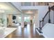Open-concept living area with hardwood floors, flowing into the kitchen and dining space at 112 Bellmont Crest Dr, Holly Springs, NC 27540