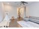 Open living room with a comfortable gray sofa and ' play area featuring a teepee and table at 112 Bellmont Crest Dr, Holly Springs, NC 27540