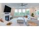 Cozy living room features a fireplace, large windows, and contemporary decor at 112 Bellmont Crest Dr, Holly Springs, NC 27540
