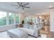 Spacious living room with a fireplace, large windows, and an open view into the modern kitchen at 112 Bellmont Crest Dr, Holly Springs, NC 27540