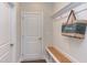 Functional mudroom with storage bench, coat hooks, and convenient access to the home at 112 Bellmont Crest Dr, Holly Springs, NC 27540