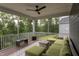 Inviting screened porch with comfortable seating and a ceiling fan for relaxation and shade at 112 Bellmont Crest Dr, Holly Springs, NC 27540