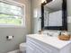 Bright bathroom with a white vanity, framed mirror, and neutral walls, offering a clean and fresh look at 114 Brenrose Cir, Durham, NC 27705