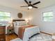 Cozy bedroom with a ceiling fan, floral bedding, woven accents, and hardwood floors complemented by a patterned rug at 114 Brenrose Cir, Durham, NC 27705