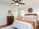 Inviting bedroom featuring a ceiling fan, hardwood floors with a decorative rug, and a comfortable, stylish setting at 114 Brenrose Cir, Durham, NC 27705
