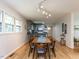 Dining room showcasing a long table with seating, open to the kitchen area, and ample lighting at 114 Brenrose Cir, Durham, NC 27705