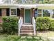 Inviting front entrance with brick steps, white railings, and a lovely green door at 114 Brenrose Cir, Durham, NC 27705