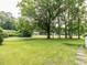 Beautiful front yard featuring mature trees and lush greenery, enhancing curb appeal at 114 Brenrose Cir, Durham, NC 27705