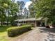 Charming brick home with a well-manicured front yard and covered carport at 114 Brenrose Cir, Durham, NC 27705