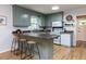 Functional kitchen with eat-in bar, white appliances, and traditional cabinetry at 114 Brenrose Cir, Durham, NC 27705
