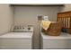 Functional laundry area with a washer and dryer, along with storage solutions at 114 Brenrose Cir, Durham, NC 27705
