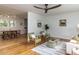 Open-concept living room adjacent to the dining area featuring hardwood floors and modern furnishings at 114 Brenrose Cir, Durham, NC 27705
