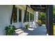 Cozy back porch with rocking chairs and ceiling fan, perfect for outdoor relaxation and enjoying the backyard view at 115 Founders Ridge Dr, Chapel Hill, NC 27517