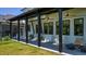 Inviting covered porch with comfortable seating, ceiling fans, and views of the well-maintained backyard at 115 Founders Ridge Dr, Chapel Hill, NC 27517