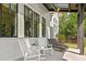 Charming back porch seating area with rocking chairs and ceiling fan, creating a relaxing outdoor space at 115 Founders Ridge Dr, Chapel Hill, NC 27517