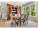 Formal dining room with decorative wallpaper, a large china cabinet, and a sunlit window view at 115 Founders Ridge Dr, Chapel Hill, NC 27517