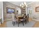 Elegant dining room featuring stylish wallpaper, chandelier lighting, and a hardwood floor at 115 Founders Ridge Dr, Chapel Hill, NC 27517