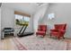 Well lit exercise room with large windows, treadmill, dumbbells, and two chairs at 115 Founders Ridge Dr, Chapel Hill, NC 27517