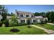 Stunning two-story home boasting a manicured lawn, mature trees, and classic architectural design at 115 Founders Ridge Dr, Chapel Hill, NC 27517