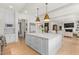 Spacious kitchen featuring a large island with granite countertops, and modern lighting at 115 Founders Ridge Dr, Chapel Hill, NC 27517