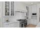 Bright kitchen features marble counters, white cabinets, subway tile backsplash, and stainless steel appliances at 115 Founders Ridge Dr, Chapel Hill, NC 27517