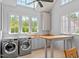 Bright laundry room has custom cabinets, a folding table and lots of sunlight and views of nature at 115 Founders Ridge Dr, Chapel Hill, NC 27517