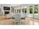 Bright living room with French doors, a glass dining table, and natural light at 115 Founders Ridge Dr, Chapel Hill, NC 27517