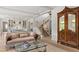 Bright and open living room featuring elegant stairs and hardwood floors at 115 Founders Ridge Dr, Chapel Hill, NC 27517