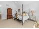 Bright main bedroom boasts a four-poster bed, sitting area and decorative wainscoting at 115 Founders Ridge Dr, Chapel Hill, NC 27517