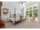 Spacious main bedroom with high ceilings, a four-poster bed, and large windows, filling the room with natural light at 115 Founders Ridge Dr, Chapel Hill, NC 27517