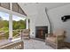 Screened porch boasts a brick fireplace and comfortable seating, perfect for enjoying the outdoors at 115 Founders Ridge Dr, Chapel Hill, NC 27517