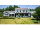 Stunning home with a manicured lawn, spacious backyard, and charming patio and porch areas at 115 Founders Ridge Dr, Chapel Hill, NC 27517