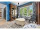 Bright sitting room features custom blue millwork and trim, designer furniture and hardwood floors at 115 Founders Ridge Dr, Chapel Hill, NC 27517