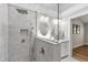Bathroom with gray tile walk-in shower, double mirrors, and sink at 115 Heatherwood Dr, Apex, NC 27502