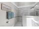 Bathroom with gray tile shower, grab bar, and blue towels at 115 Heatherwood Dr, Apex, NC 27502