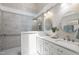Modern bathroom featuring double sinks, sleek countertops, and a stylish glass-enclosed shower with gray tiling at 115 Heatherwood Dr, Apex, NC 27502