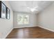 Bright bedroom with hardwood floors, white trim, and a ceiling fan at 115 Heatherwood Dr, Apex, NC 27502