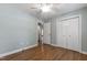 Bedroom featuring hardwood floors, closet doors, and natural light at 115 Heatherwood Dr, Apex, NC 27502