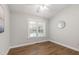 Cozy bedroom with a window, hardwood floors, and simple decor at 115 Heatherwood Dr, Apex, NC 27502