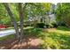 Well-maintained home with lush landscaping and mature shade trees at 115 Heatherwood Dr, Apex, NC 27502