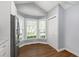Bright kitchen nook featuring three windows and wood-look flooring at 115 Heatherwood Dr, Apex, NC 27502