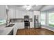 Bright and modern kitchen featuring stainless steel appliances, sleek countertops, and ample cabinet space at 115 Heatherwood Dr, Apex, NC 27502