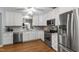 A functional kitchen showcasing stainless steel appliances, ample counter space, and updated cabinets at 115 Heatherwood Dr, Apex, NC 27502